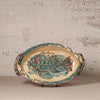 Ceramic platter with fish design on a textured surface