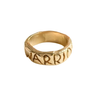 Gold ring with 'warrior' engraved on a white background