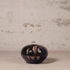 Ceramic vase with abstract design on a textured surface