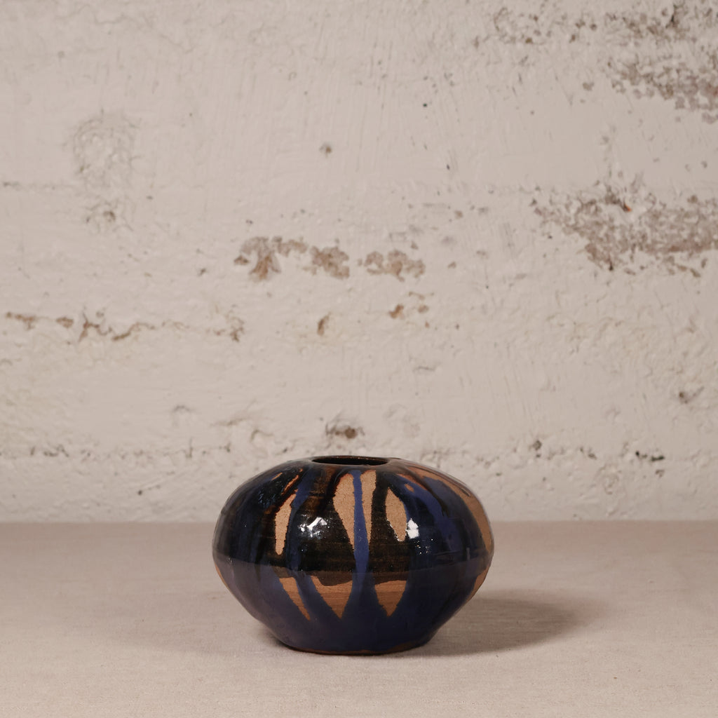 Ceramic vase with abstract design on a textured surface