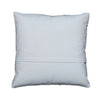 A square white throw pillow with a stitched hem and decorative bead trim along the edges, displayed flat on a gray wooden plank surface.