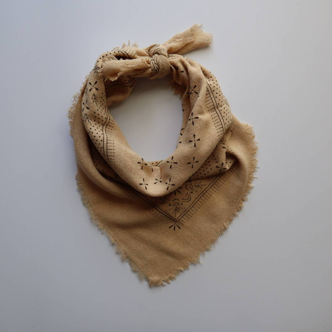 Beige patterned scarf on a light gray background