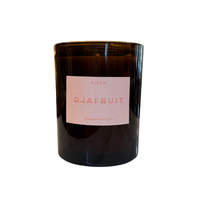 An amber glass jar candle with a pale pink label reading 'ROEN OJAI NUIT' on a plain white background.