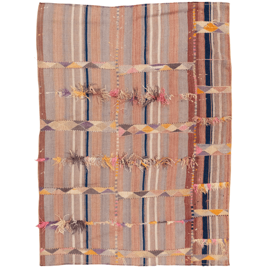 Handwoven wool Kilim with soft stripes and fringe accents, featuring pink, navy, and burgundy tones.