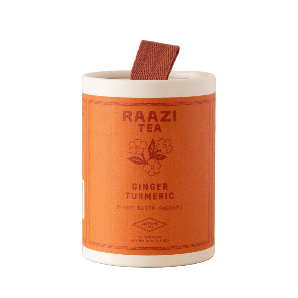 Orange and white container of Raazi Tea Ginger Turmeric on a beige background