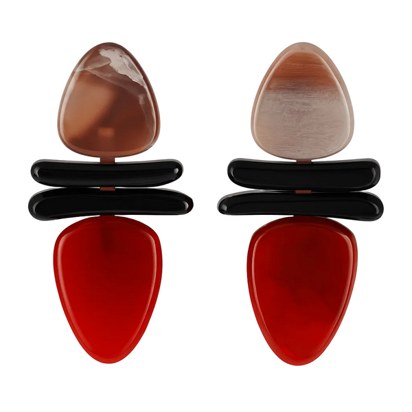 Pair of earrings with brown, black, and red stones on a white background