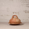 Ceramic container with lid on a textured surface