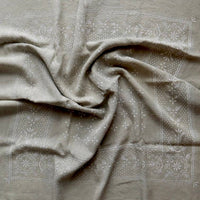 Textured fabric with subtle patterns on a neutral background