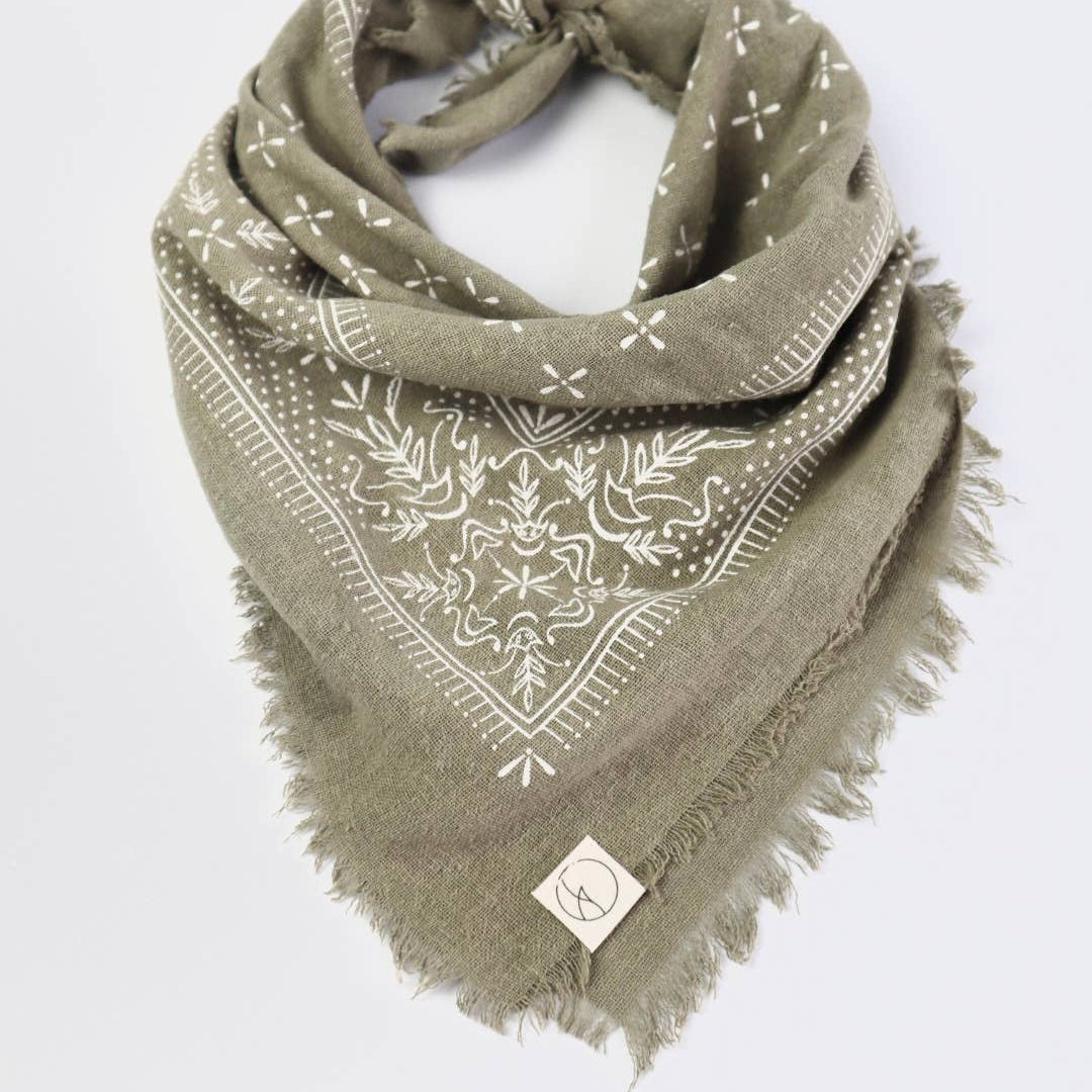 Green bandana with white patterns on a light gray background