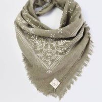 Green bandana with white patterns on a light gray background
