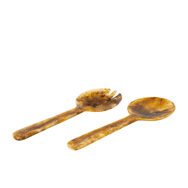 Set of two tortoiseshell resin salad servers on white background