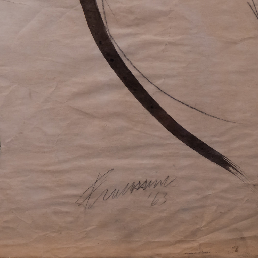 A close-up of a beige or cream-colored textured paper with a large dark brown curved brushstroke and a faint handwritten signature near the bottom center.