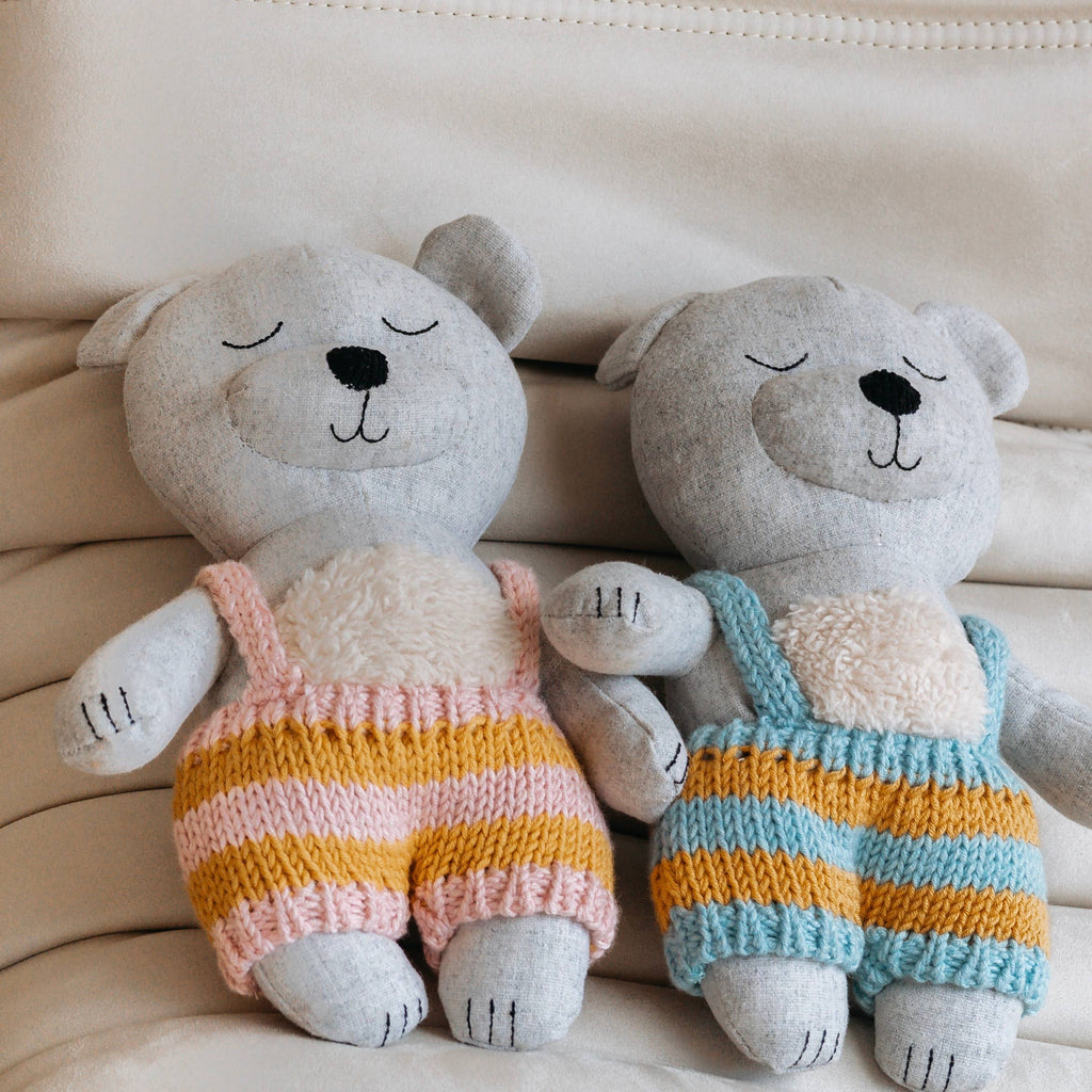 Spencer Bears sitting next to each other one is pink and the other is blue 