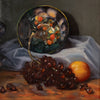 A still life oil painting depicting a dark bowl filled with red cherries, a bunch of dark grapes, and an orange on draped white fabric over a wooden table.