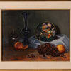 A framed still life painting depicting a dark blue vase, a jar, grapes, peaches, and an orange on draped fabric against a dark background.