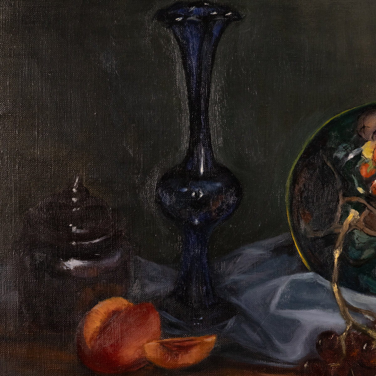 A still life painting featuring a tall dark blue glass vase, sliced peaches, a small dark jar, draped white fabric, and part of a decorative plate on a dark background.