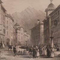 Vintage engraving of a bustling street scene with people and animals in an urban setting with mountains in the background.