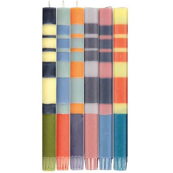 Set of five colorful striped candles on a white background