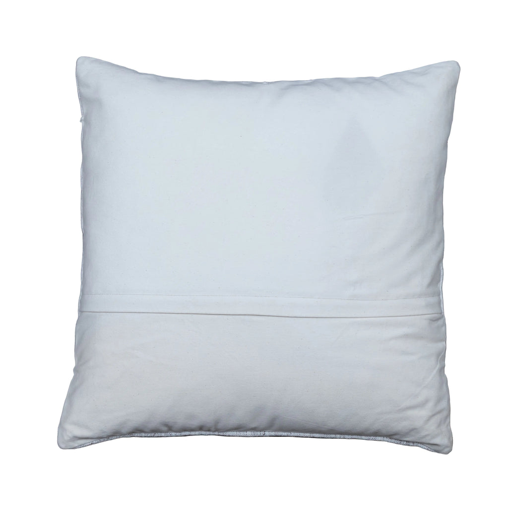 A square white throw pillow with a horizontal stitched seam across the middle, displayed flat on a gray wooden plank surface.