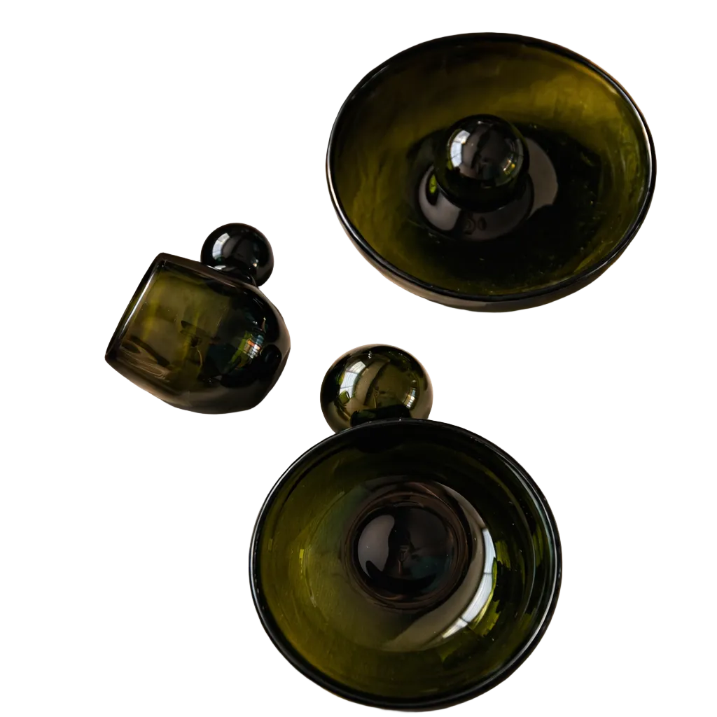 Green glass bowls on a beige fabric surface