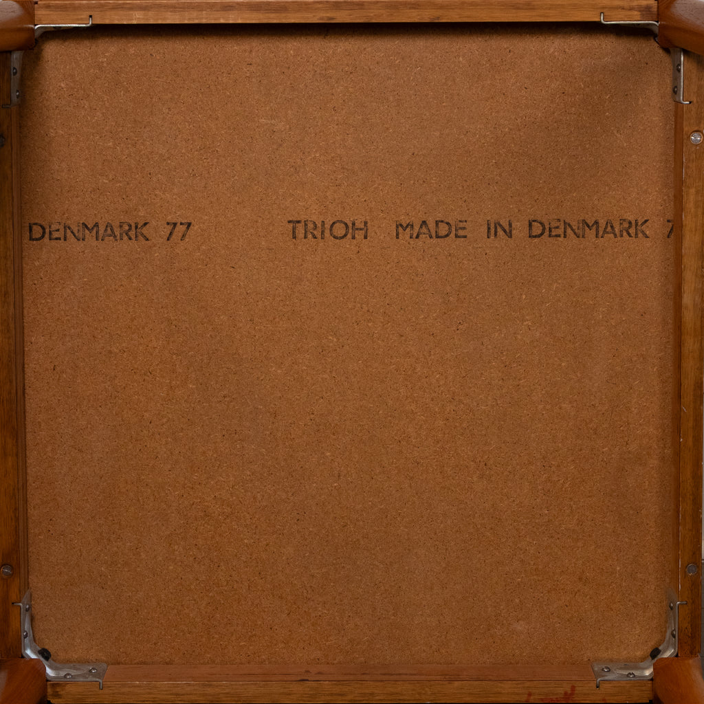 The back of a wooden framed picture or mirror, showing a brown textured backing board with metal corner brackets and printed text reading 'DENMARK 77' and 'TRIOH MADE IN DENMARK 77'.