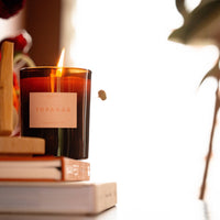 Topanga candle on books with a blurred background