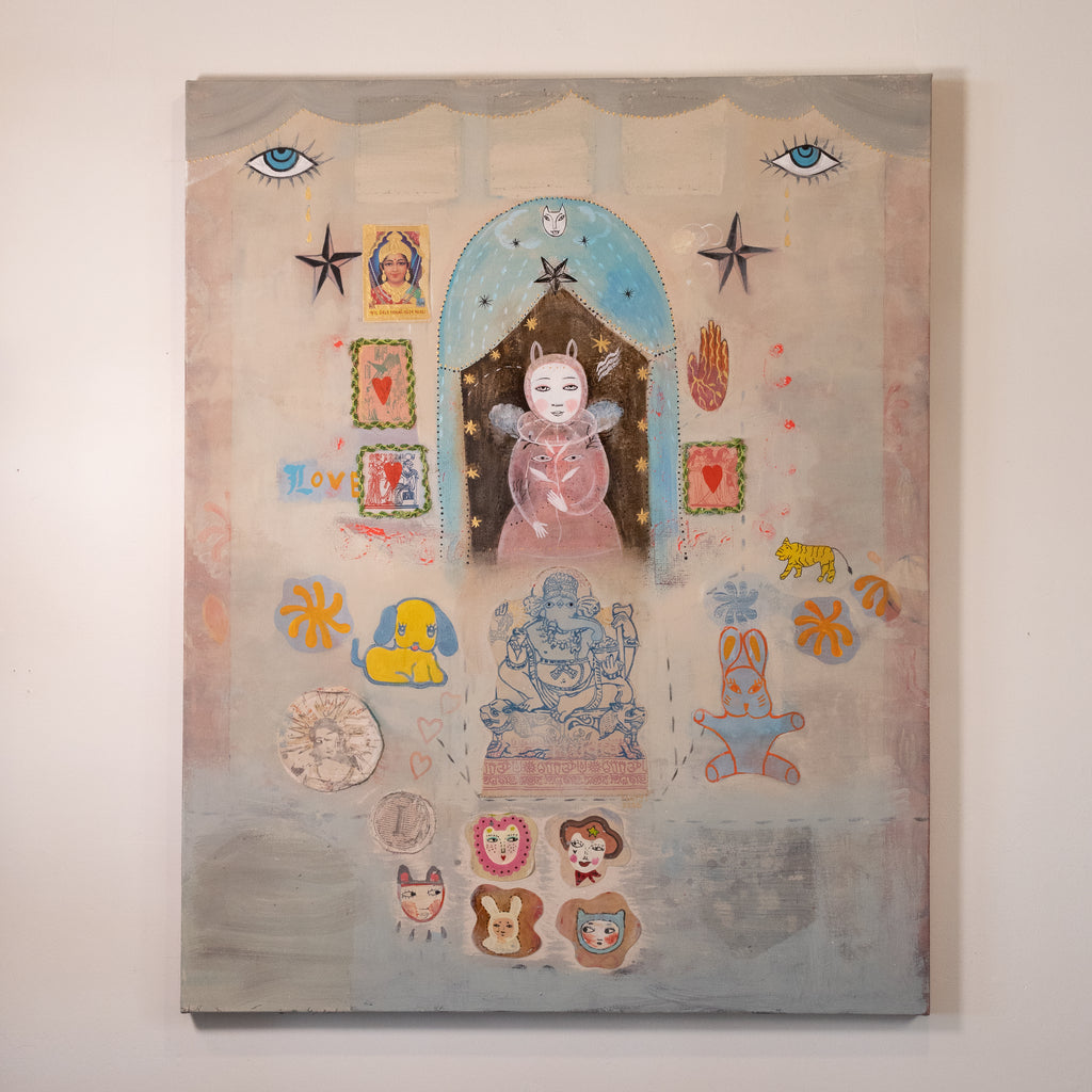 A surreal, collage-style painting hanging on a light beige wall. The artwork features a central pink figure under a blue arch, surrounded by whimsical elements including blue eyes, stars, small animal figures, decorative frames, and pastel accents in yellow, orange, and red.