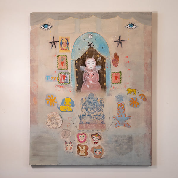A surreal, collage-style painting hanging on a light beige wall. The artwork features a central pink figure under a blue arch, surrounded by whimsical elements including blue eyes, stars, small animal figures, decorative frames, and pastel accents in yellow, orange, and red.