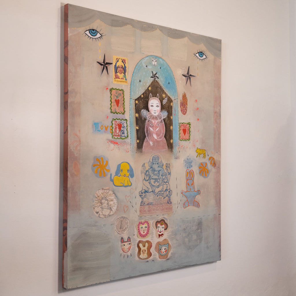 A vertical mixed-media collage painting on canvas, featuring a whimsical central figure in a pink dress under a blue arch, surrounded by stars, animal motifs, and small decorative elements on a textured beige and blue background, hanging on a white wall.