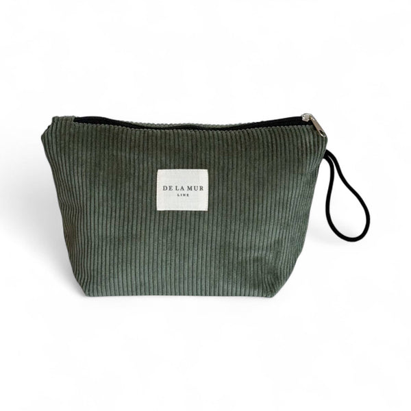 Green ribbed clutch bag with a visible brand label on a white background