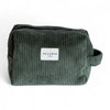 Green corduroy pouch with a visible brand label on a white background
