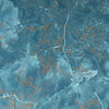 A close-up of a blue marble-like surface with white veining and scattered metallic copper-orange flecks.