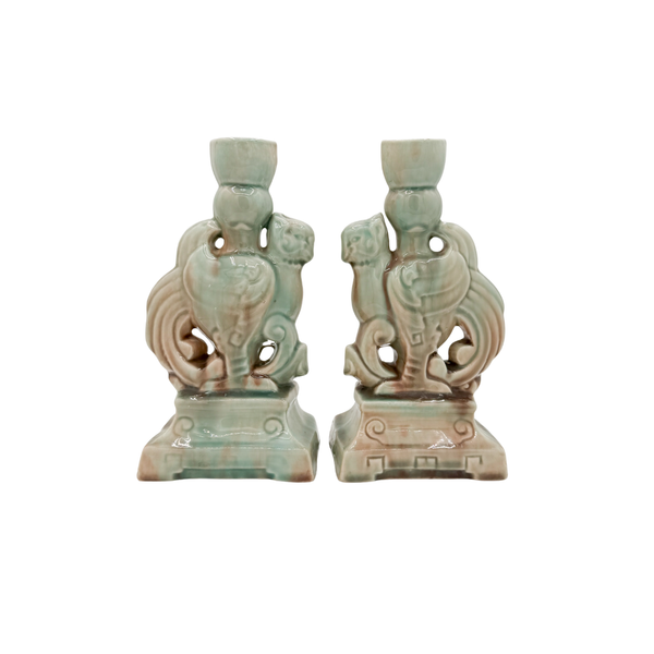 Pair of decorative ceramic candle holders on a white background