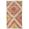 Handwoven wool Turkish Kilim rug with diamond pattern in sage green, red, light blue, orange, and off-white.