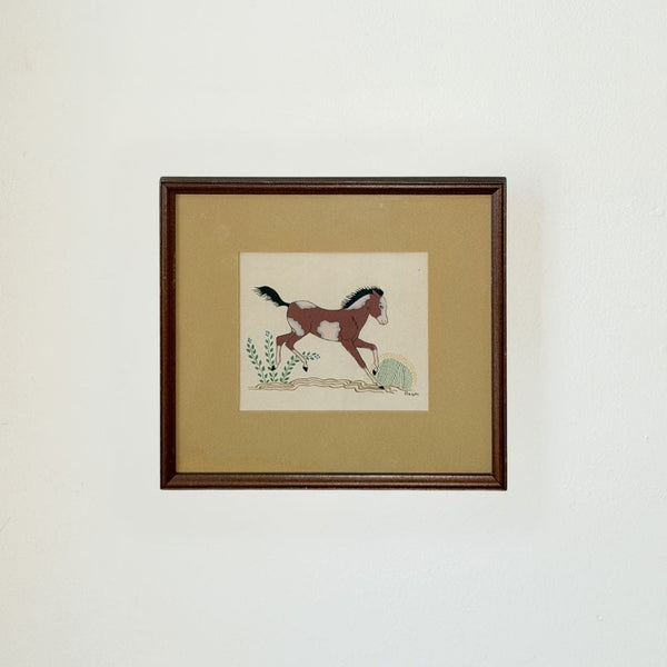 Framed artwork of a horse on a beige background