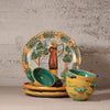 Set of ceramic dishes with artistic designs on a textured surface