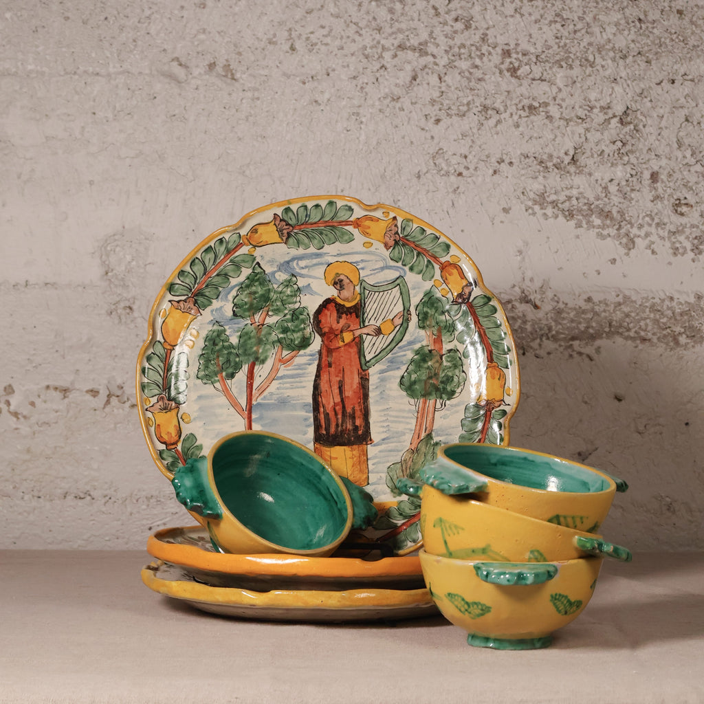 Set of ceramic dishes with artistic designs on a textured surface