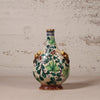 Decorative ceramic vase with floral patterns on a textured surface