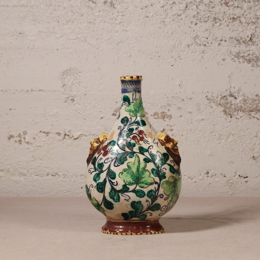 Decorative ceramic vase with floral patterns on a textured surface