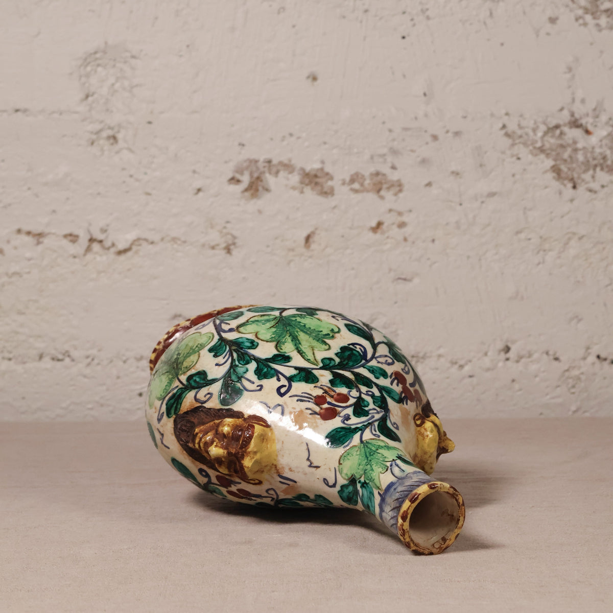 Decorative ceramic vase with floral patterns on a textured surface