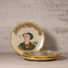 Decorative ceramic plates with artistic designs on a textured surface
