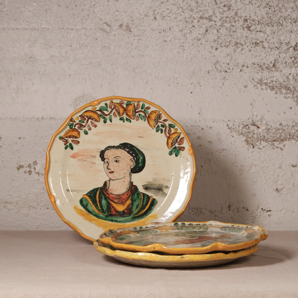 Decorative ceramic plates with artistic designs on a textured surface