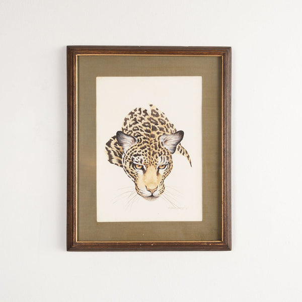 Framed artwork of a leopard's head on a light background