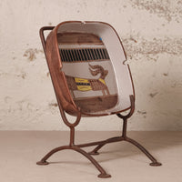 A vintage-style metal ashtray with a brown rusted frame and stand, featuring a white interior decorated with a brown horse graphic and a yellow cigarette pack illustration.