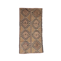 A rectangular hand-woven area rug with a geometric diamond pattern in shades of brown, beige, and muted orange, shown flat against a solid white background.