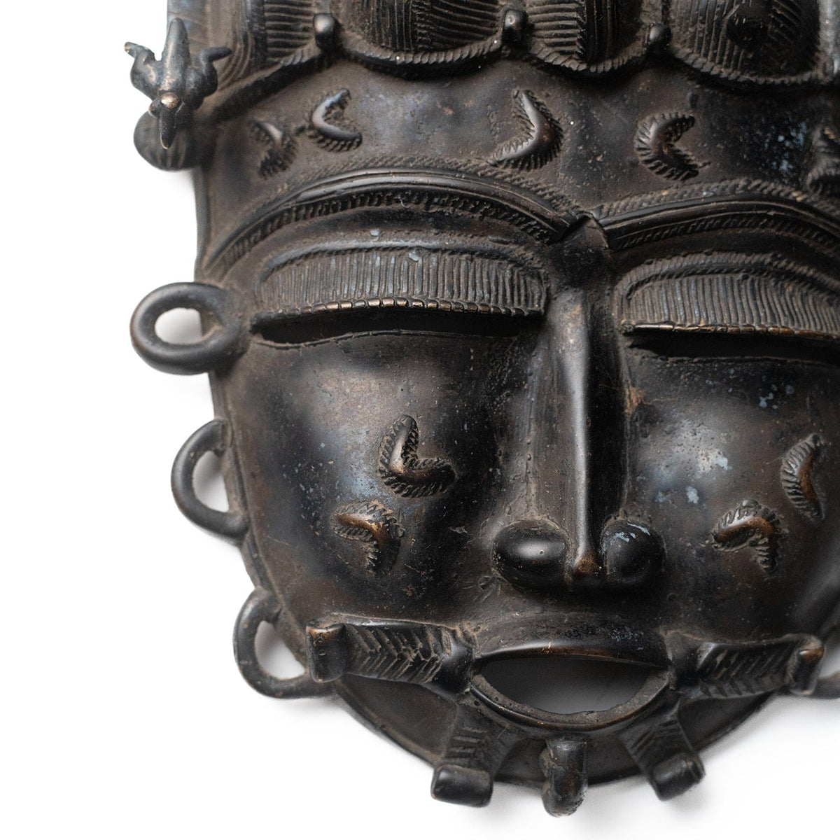 Vintage African bronze mask from Ivory Coast – reverse view