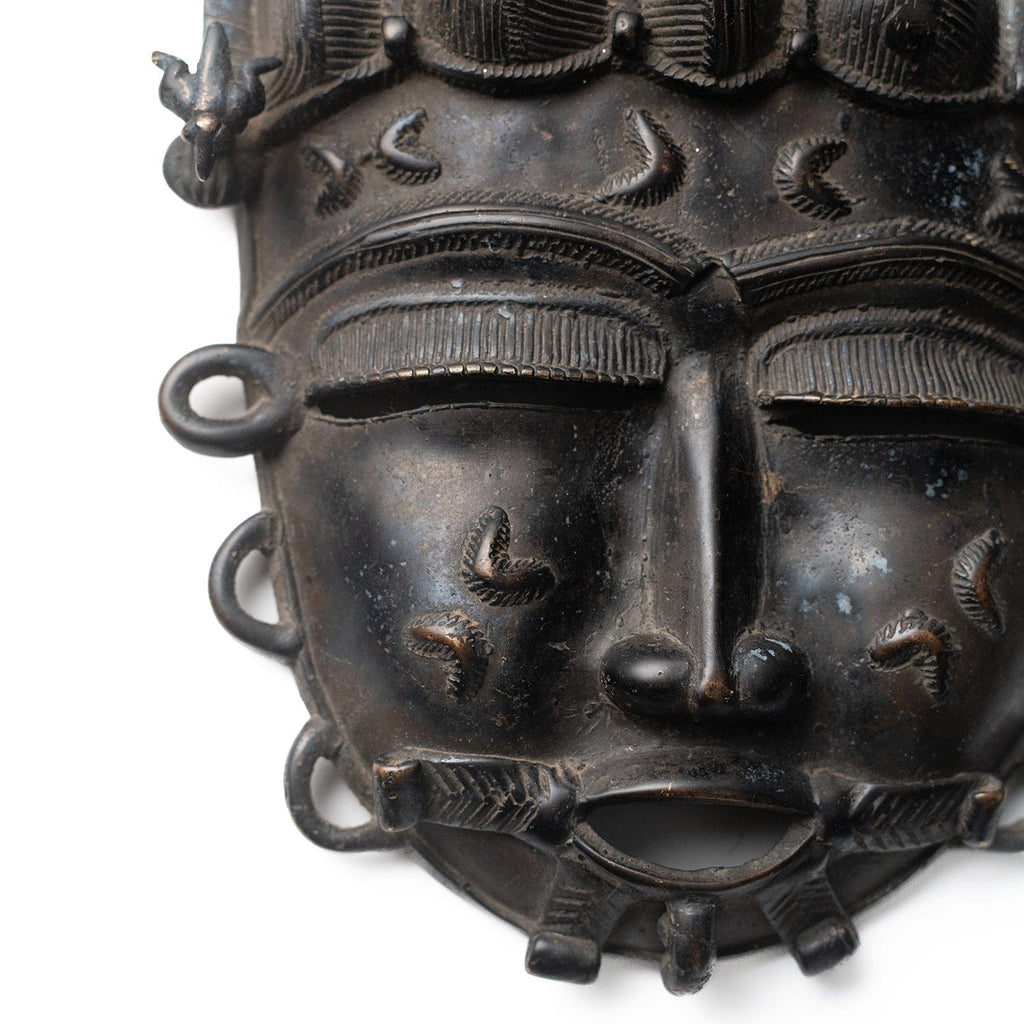 Vintage African bronze mask from Ivory Coast – reverse view
