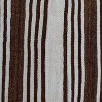 A close-up of a woven textile with vertical stripes in dark brown, medium brown, and off-white, showing a detailed texture.
