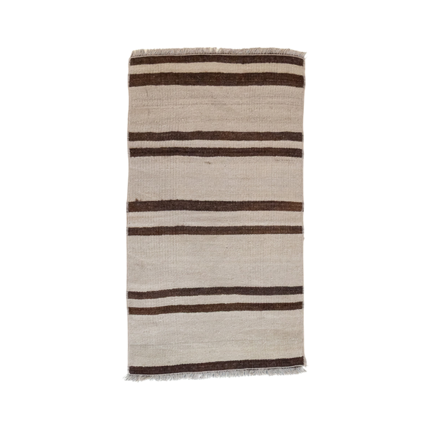 A rectangular woven rug with horizontal stripes in dark brown and beige, featuring fringed edges, shown against a plain white background.