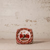 Decorative ceramic square ashtray with a bird design on a textured surface